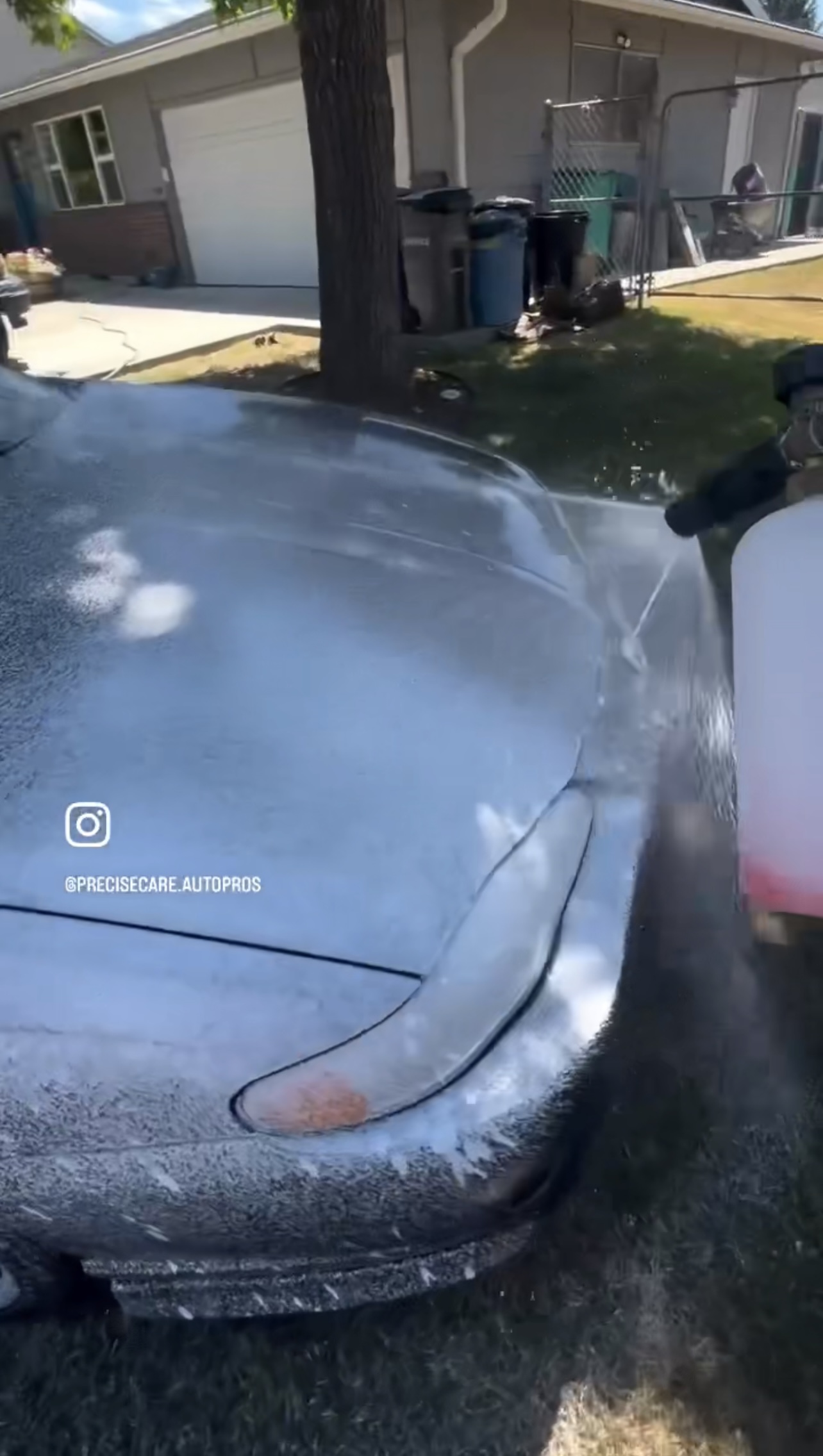 Instagram post preview - Car being washed with soap and foam in residential driveway